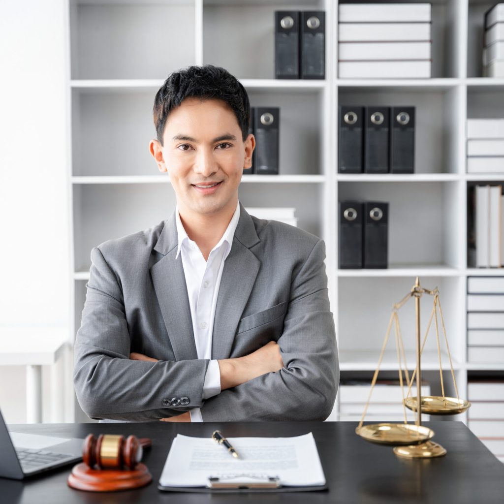Lawyer office. gavel of Justice with scales and lawyer working on a laptop. Legal law, advice and justice concept.